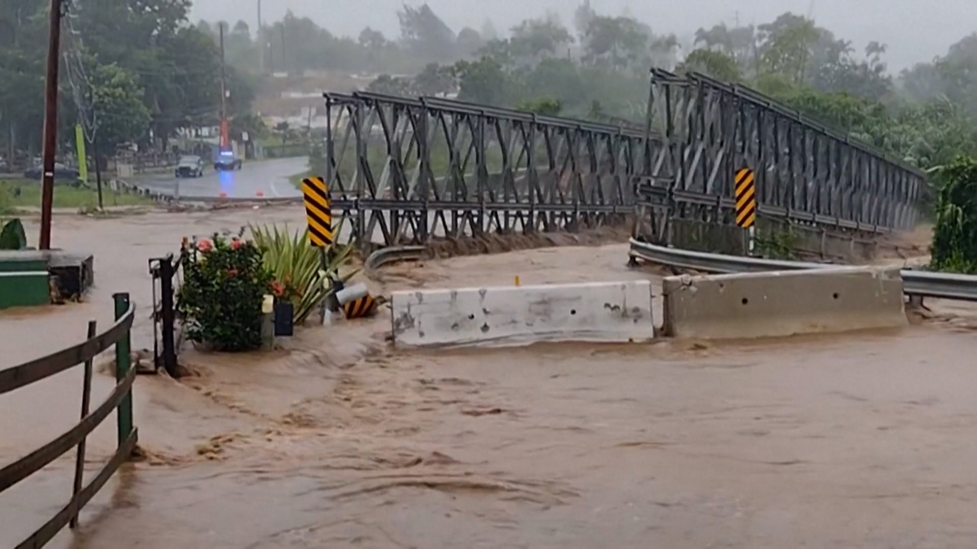 Floodwaters sweep away bridge as Hurricane Fiona wreaks havoc in Puerto Rico